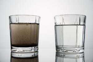An image of contaminated water compared to clean drinking water.