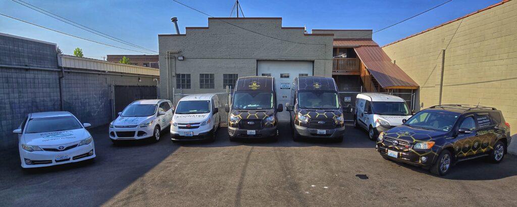 The Real H2O Solutions & Ecowater Spokane Vehicles lined up in the back of the company store