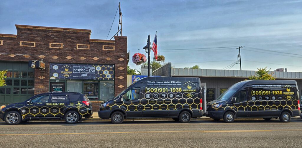 Real H2O Solutions branded vehicles lined up in front of the front of our office