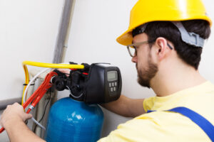 Water technician servicing water filtration system