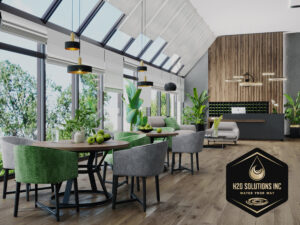 Image of the inside of a hotel lobby with dining tables, chails, a couch, a fireplace, and windows